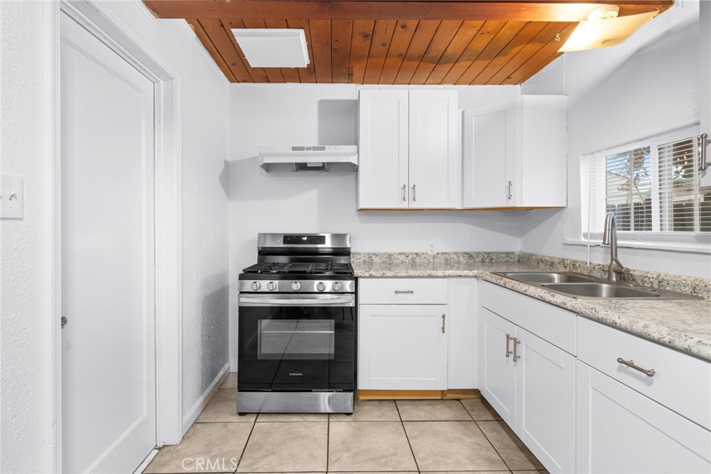 1675 Rose Avenue Merced, CA 95341 - Photo 5 of 17 a kitchen with cabinets appliances and a window