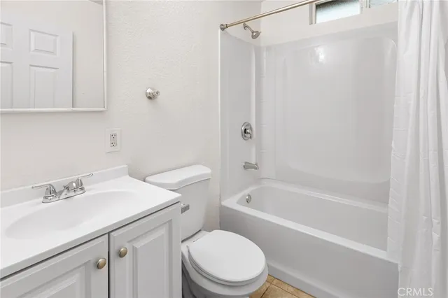 a white toilet sitting next to a bath tub