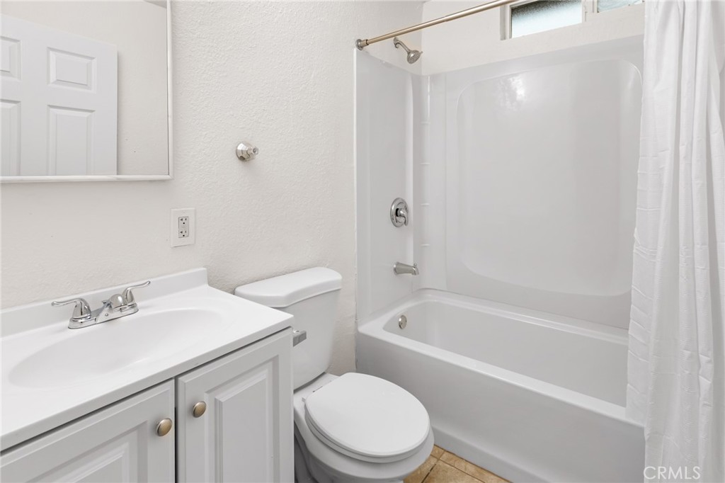 1675 Rose Avenue Merced, CA 95341 - Photo 9 of 17 a white toilet sitting next to a bath tub