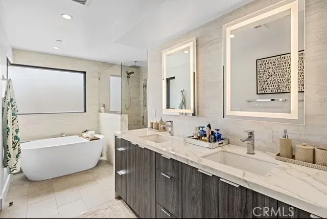 a bathroom with a double vanity sink tub and a mirror