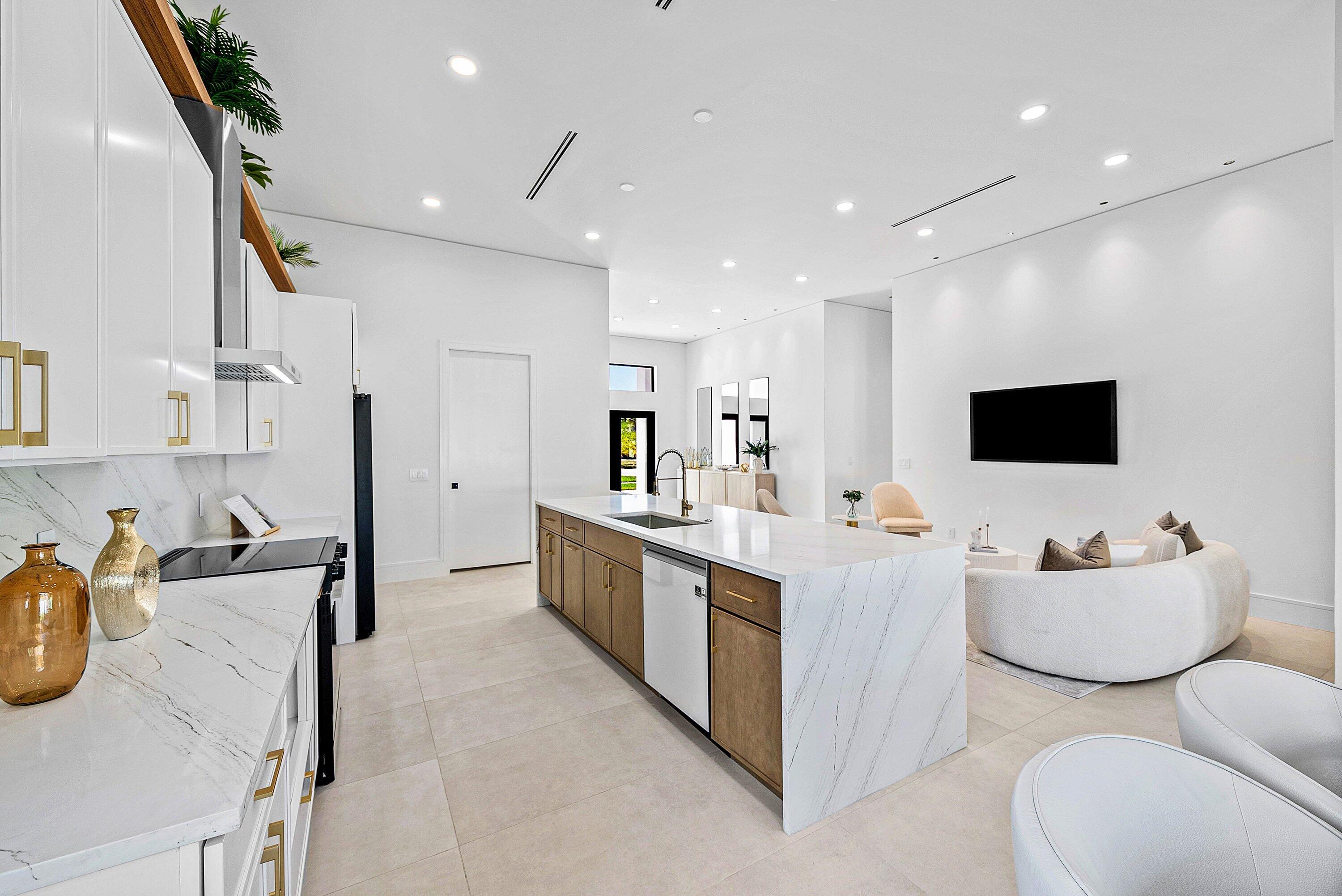 3361 Northeast 4th Avenue Boca Raton, FL 33431 - Photo 15 of 44 a large white room with stainless steel appliances kitchen island granite countertop a sink and chairs