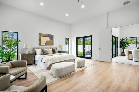 a large room with lot of counter space a sink and a bed