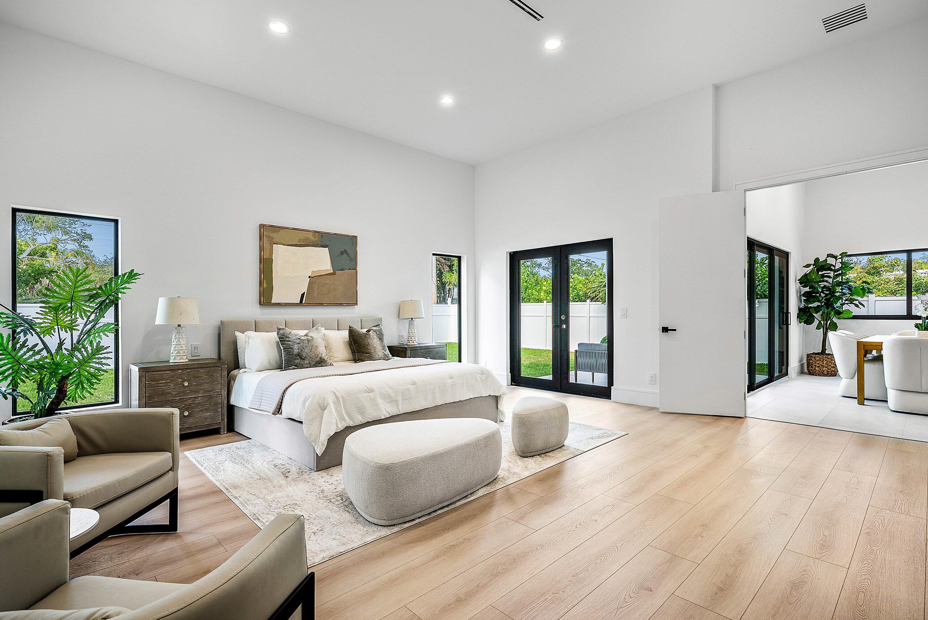 3361 Northeast 4th Avenue Boca Raton, FL 33431 - Photo 16 of 44 a spacious bedroom with a large bed and a couch