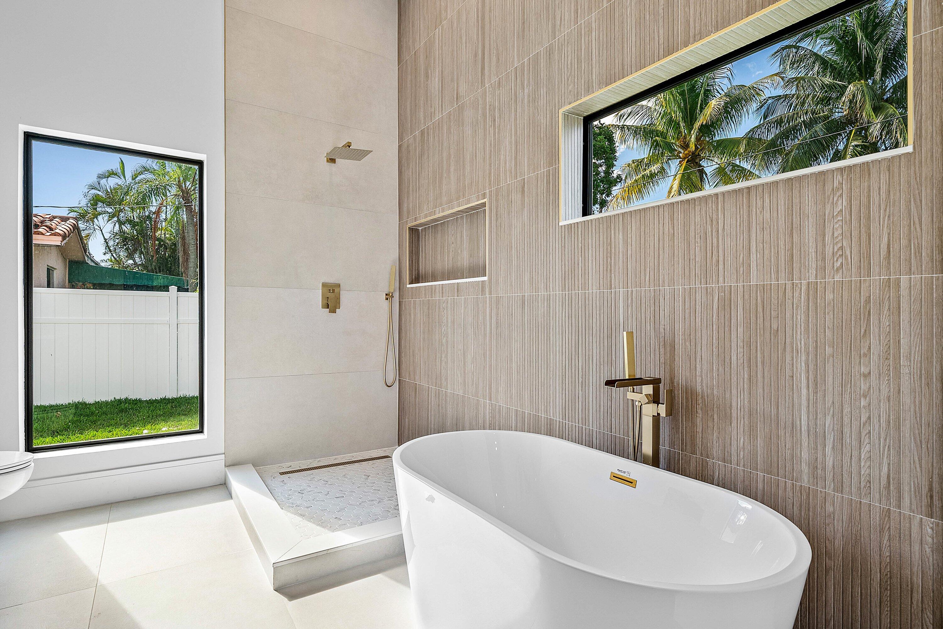 3361 Northeast 4th Avenue Boca Raton, FL 33431 - Photo 18 of 44 a bathroom with a white bath tub and a shower