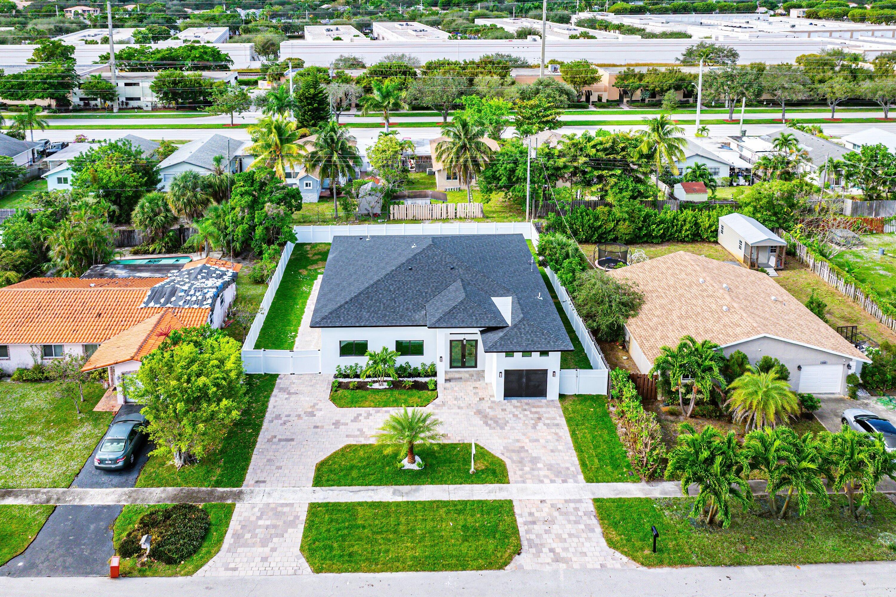 3361 Northeast 4th Avenue Boca Raton, FL 33431 - Photo 2 of 44 a view of a garden with plants and large trees