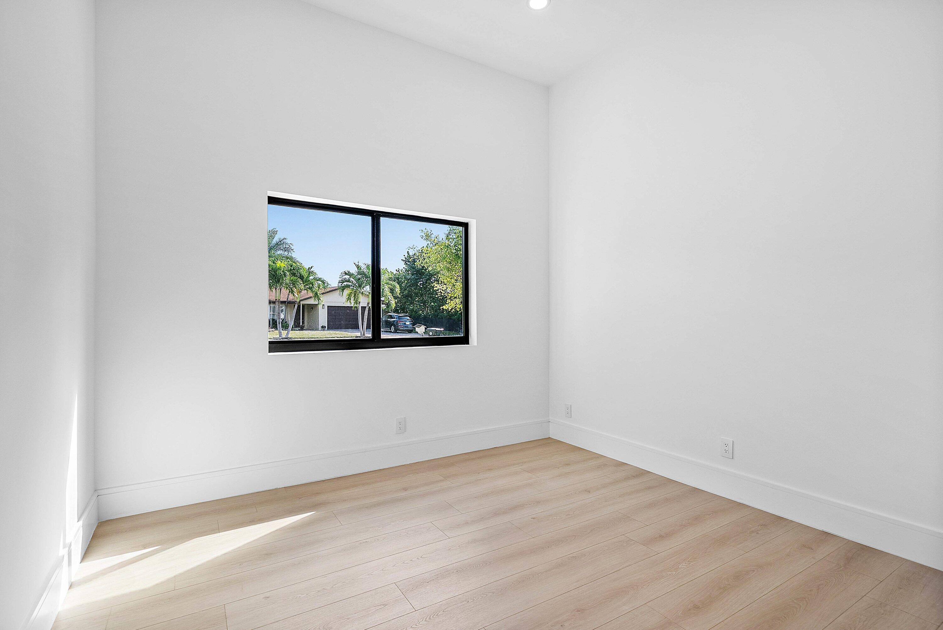 3361 Northeast 4th Avenue Boca Raton, FL 33431 - Photo 20 of 44 an empty room with wooden floor and window