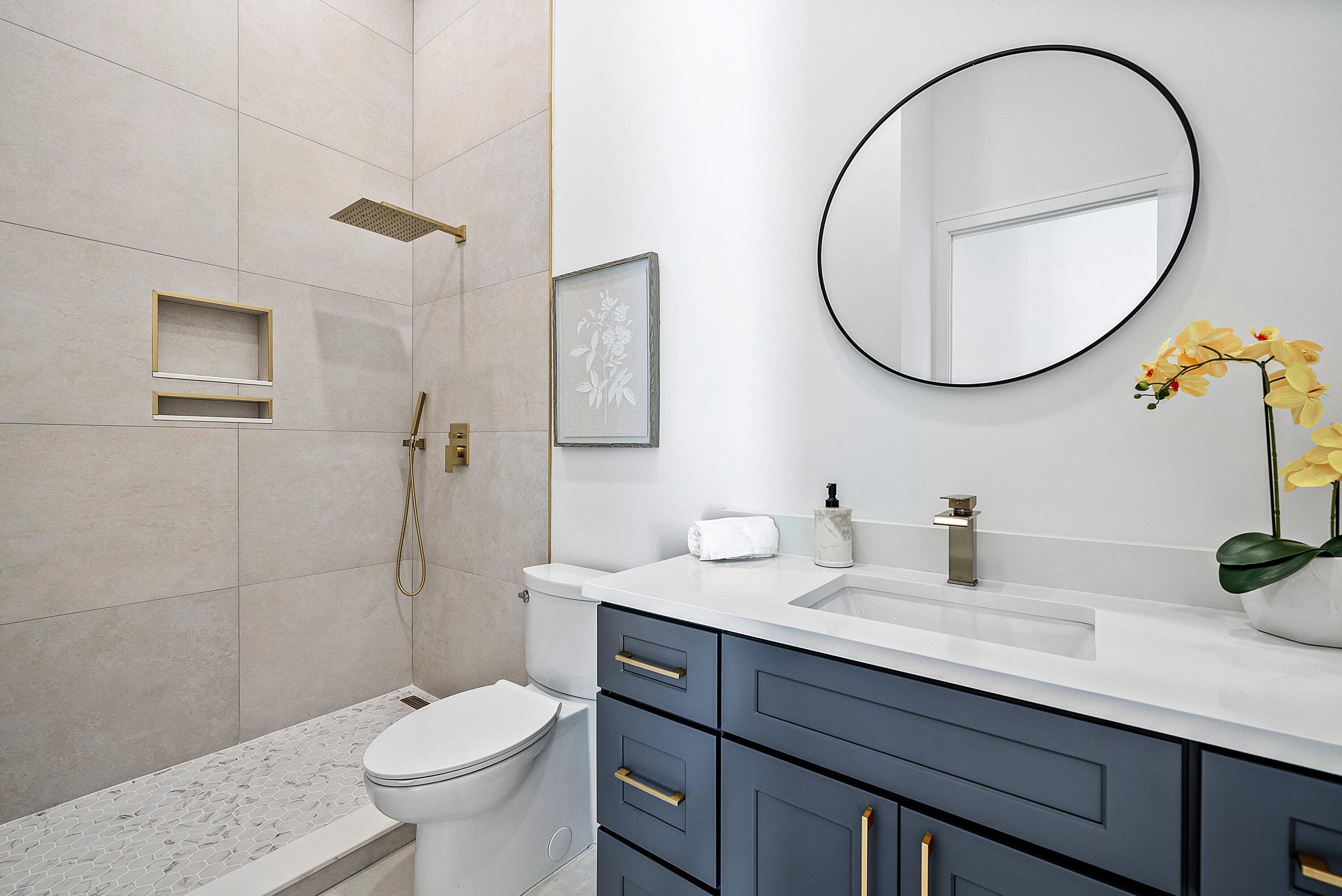 3361 Northeast 4th Avenue Boca Raton, FL 33431 - Photo 24 of 44 a bathroom with a sink a toilet and a mirror