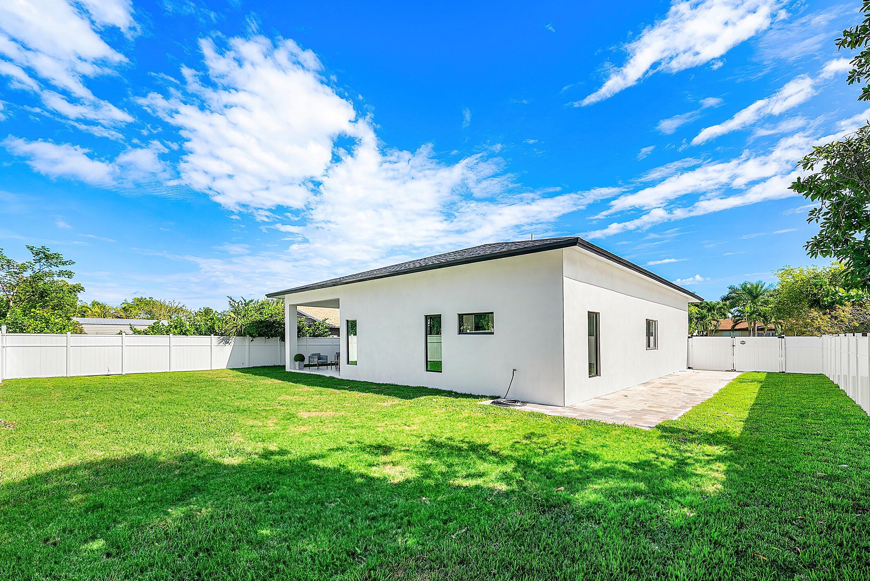 3361 Northeast 4th Avenue Boca Raton, FL 33431 - Photo 28 of 44 a view of a house with a yard