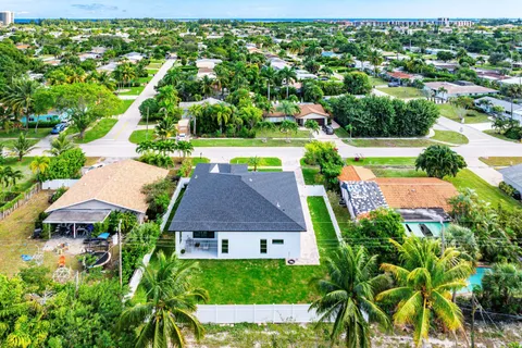 an aerial view of a house with garden space and street view