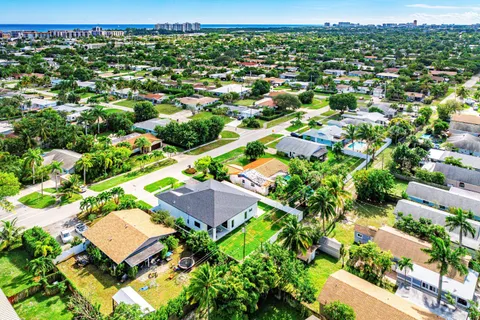 an aerial view of a house with a yard basket ball court and outdoor seating