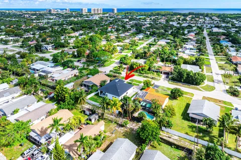 an aerial view of a house with a yard