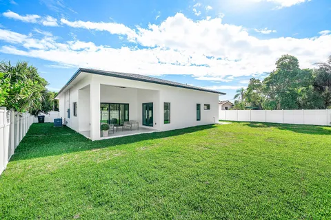 a view of a backyard with plants and a garden