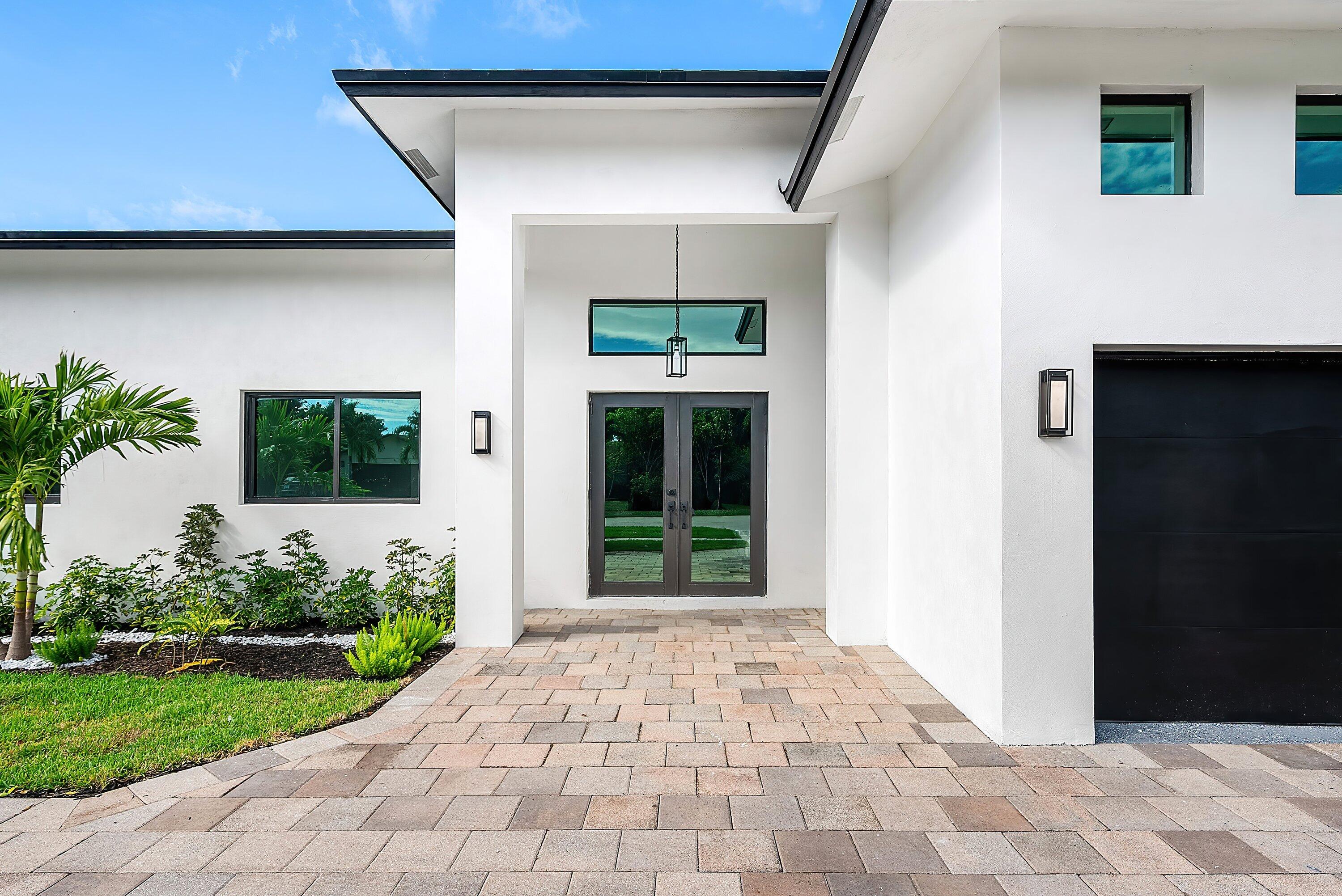 3361 Northeast 4th Avenue Boca Raton, FL 33431 - Photo 6 of 44 a front view of a house with a porch