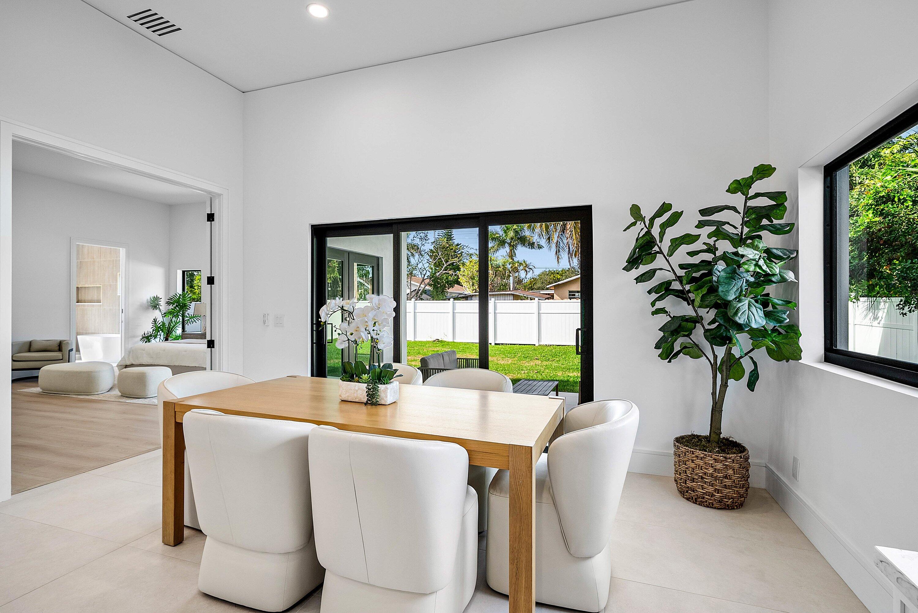 3361 Northeast 4th Avenue Boca Raton, FL 33431 - Photo 10 of 44 a dining room with furniture and a potted plant