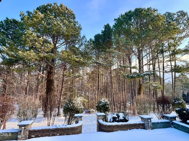 a view of a dining room with furniture a chandelier and wooden floor
