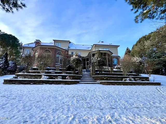 a view of an entryway wooden floor and a chandelier