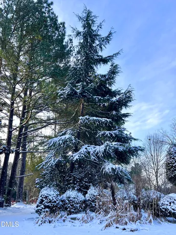 a view of an empty room with a fireplace and a large window