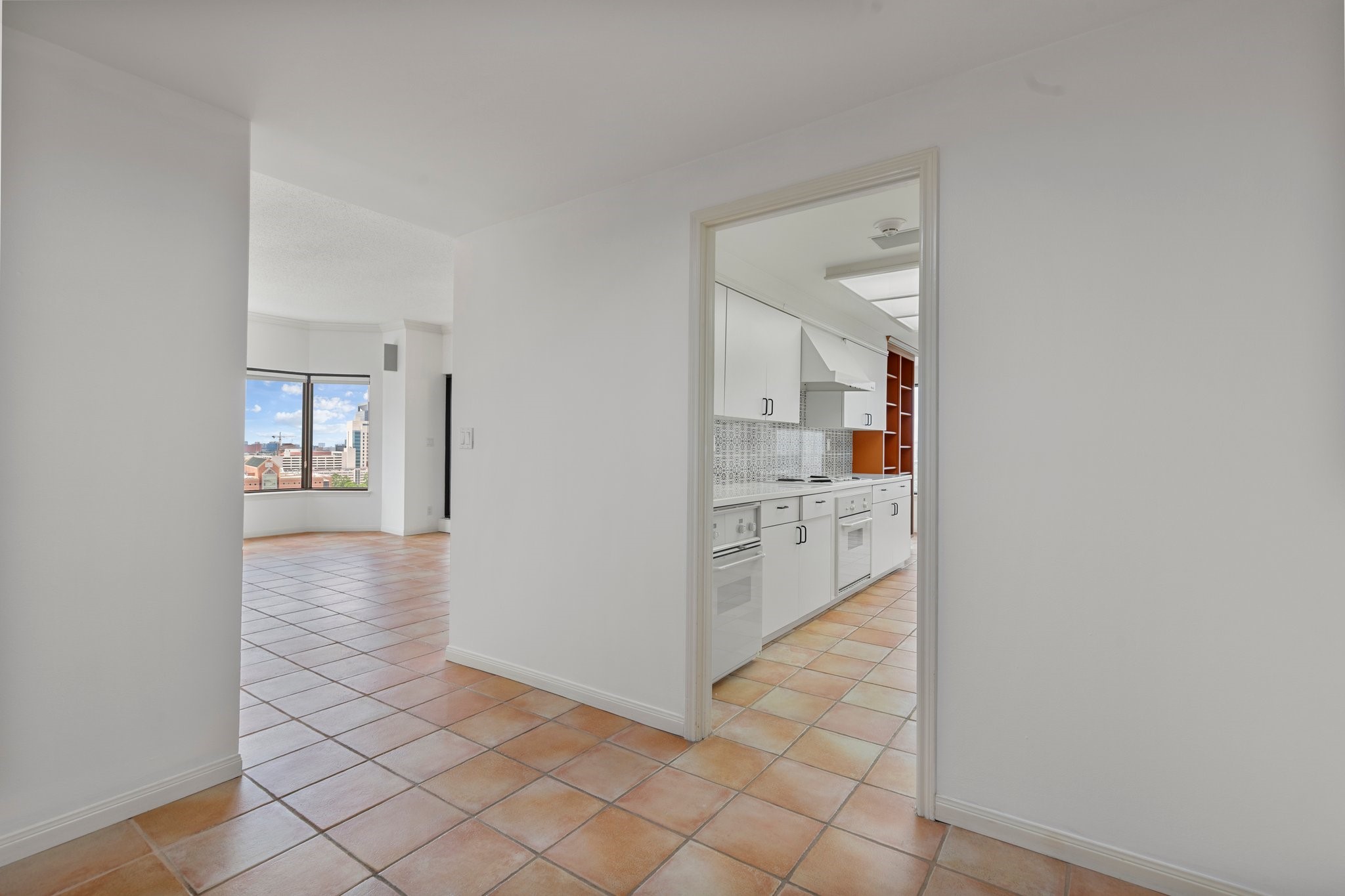 2001 Holcombe Boulevard, Unit 1801 Houston, TX 77030 - Photo 11 of 31 a view of a hallway with white cabinets and wooden floor