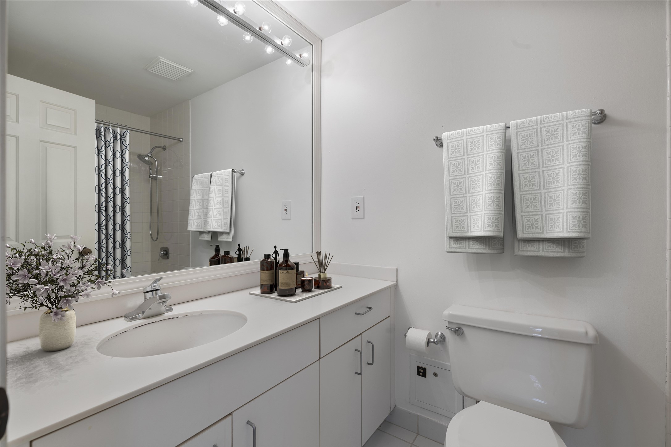 2001 Holcombe Boulevard, Unit 1801 Houston, TX 77030 - Photo 15 of 31 a bathroom with a sink toilet and mirror