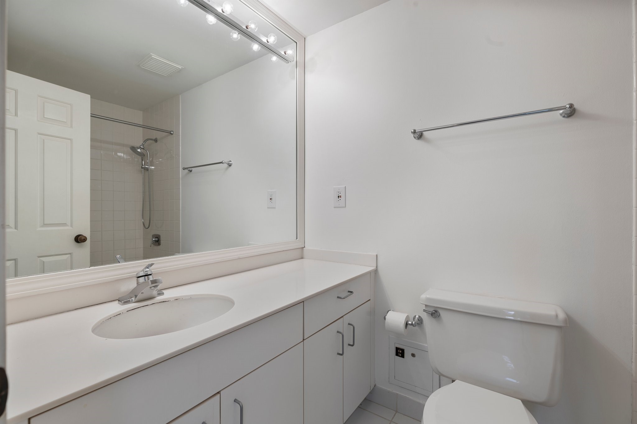2001 Holcombe Boulevard, Unit 1801 Houston, TX 77030 - Photo 16 of 31 a bathroom with a sink toilet vanity and shower