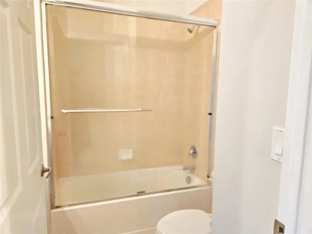 a bathroom with a shower and a bath tub