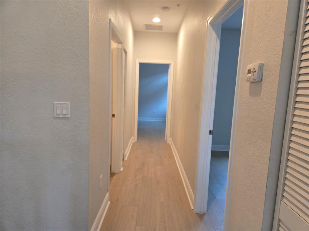 1528 Southwest 147th Avenue, Unit 1527 Pembroke Pines, FL 33027 - Photo 15 of 18 a view of a hallway with wooden floor