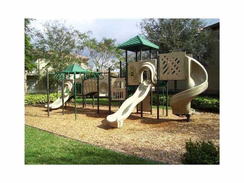 1528 Southwest 147th Avenue, Unit 1527 Pembroke Pines, FL 33027 - Photo 6 of 18 a park view with a slide sitting space