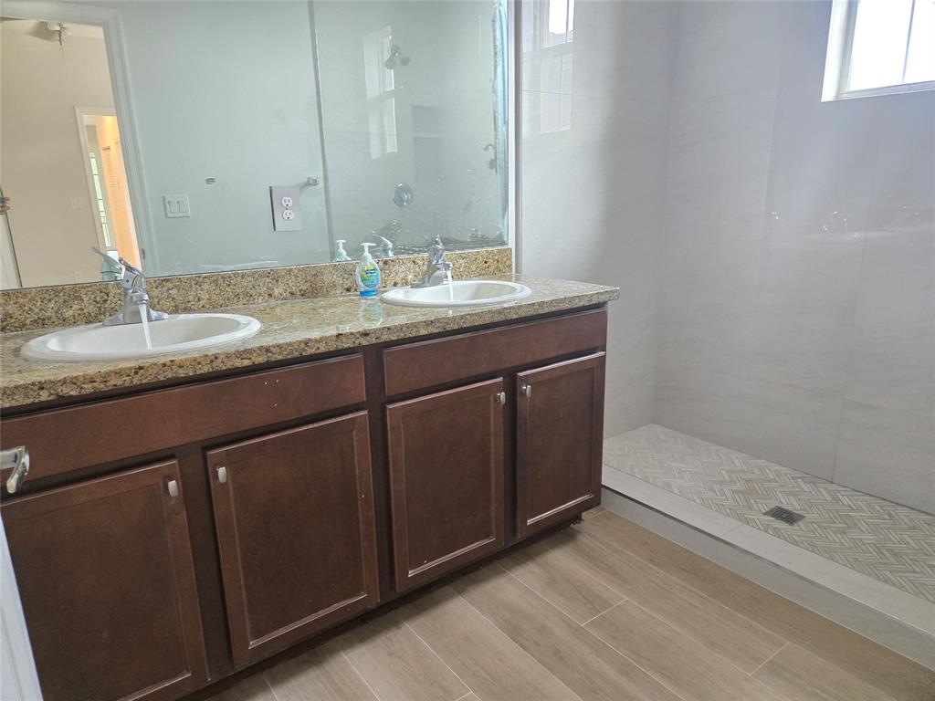 1528 Southwest 147th Avenue, Unit 1527 Pembroke Pines, FL 33027 - Photo 8 of 18 a bathroom with a granite countertop sink and a mirror