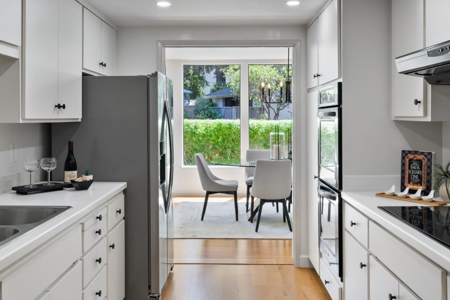 300 Sand Hill Circle, Unit 101 Menlo Park, CA 94025 - Photo 15 of 47 a kitchen with a table chairs refrigerator and cabinets