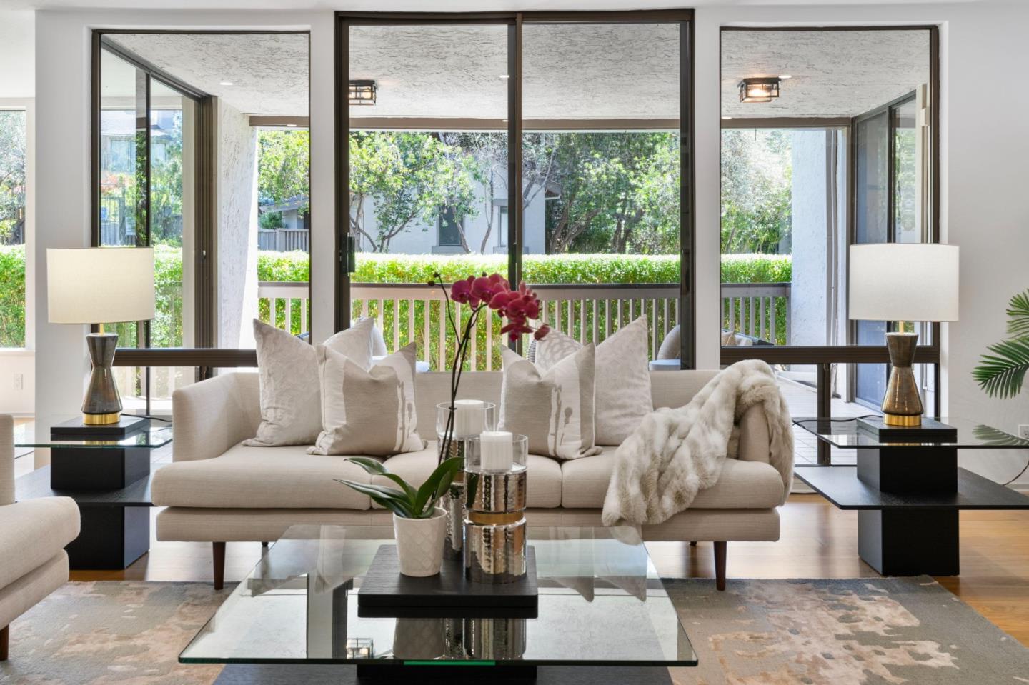 300 Sand Hill Circle, Unit 101 Menlo Park, CA 94025 - Photo 2 of 47 a living room with furniture and floor to ceiling windows