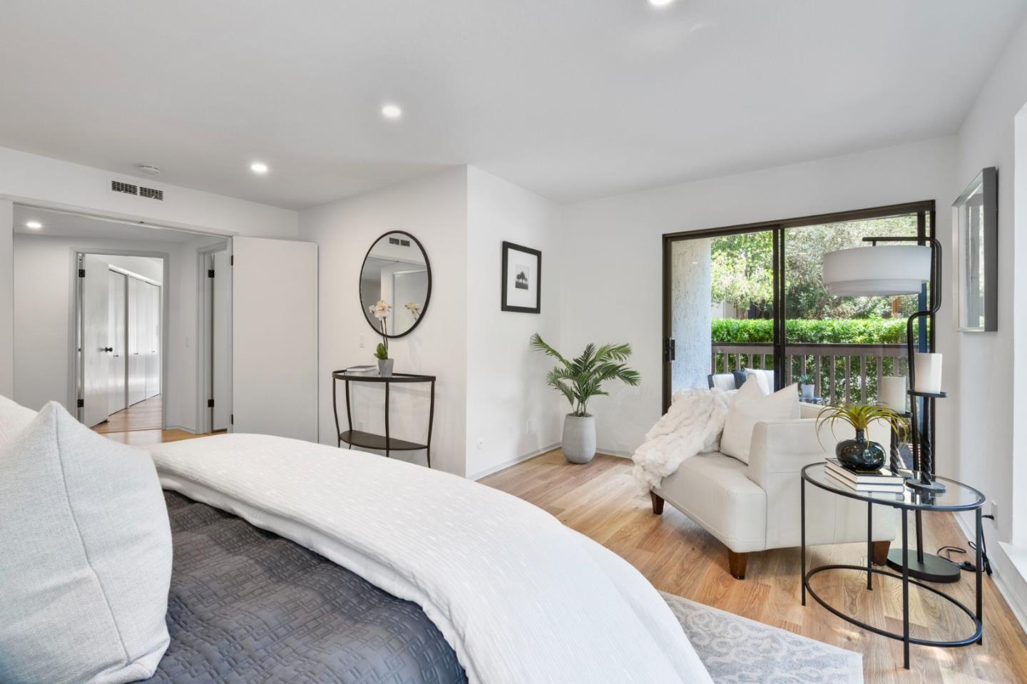 300 Sand Hill Circle, Unit 101 Menlo Park, CA 94025 - Photo 24 of 47 a spacious bedroom with a large bed and a large window