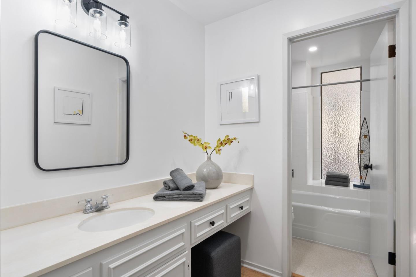 300 Sand Hill Circle, Unit 101 Menlo Park, CA 94025 - Photo 33 of 47 a bathroom with a granite countertop sink and a mirror