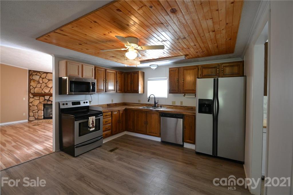 3511 Thunder Road Maiden, NC 28650 - Photo 16 of 44 a kitchen with stainless steel appliances kitchen island granite countertop a stove a sink and a refrigerator
