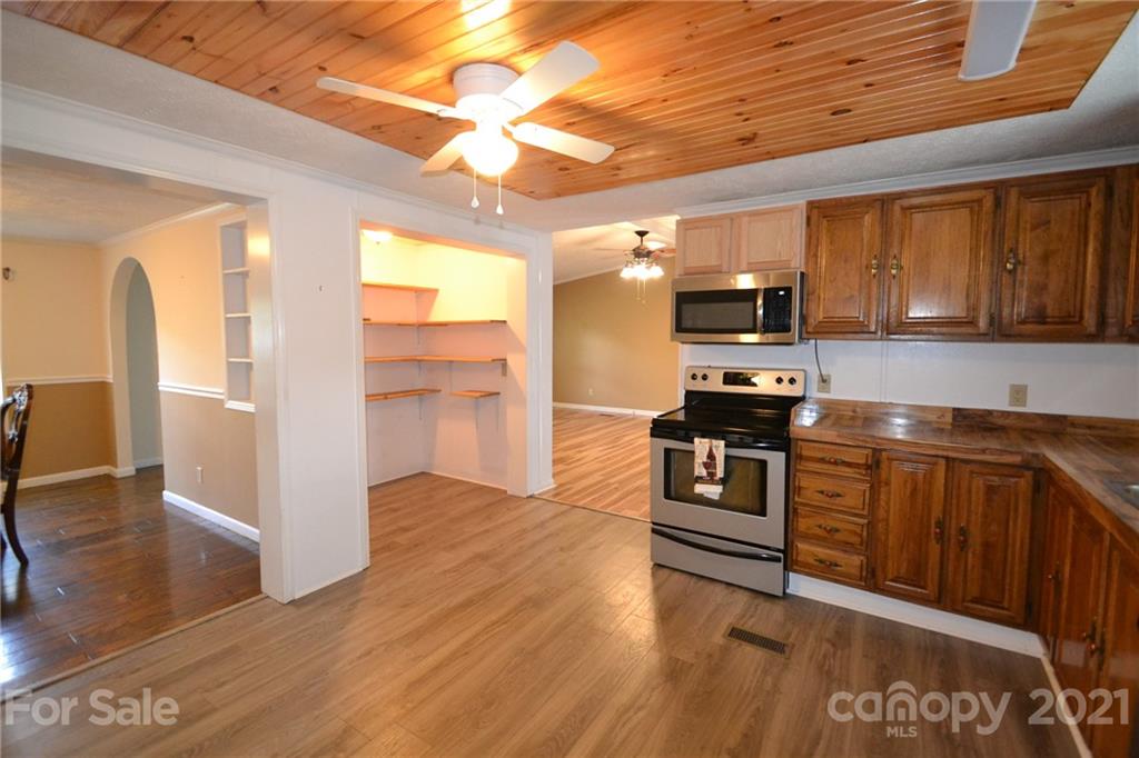 3511 Thunder Road Maiden, NC 28650 - Photo 17 of 44 a kitchen with stainless steel appliances kitchen island granite countertop a stove and a sink