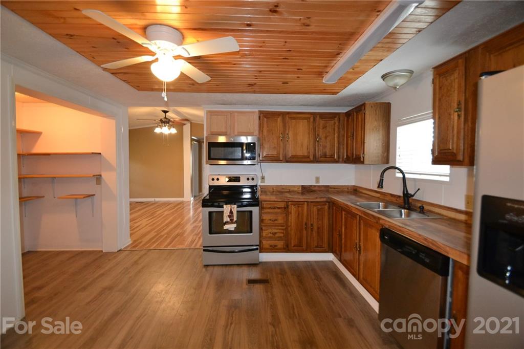 3511 Thunder Road Maiden, NC 28650 - Photo 18 of 44 a kitchen with granite countertop a sink cabinets and stainless steel appliances