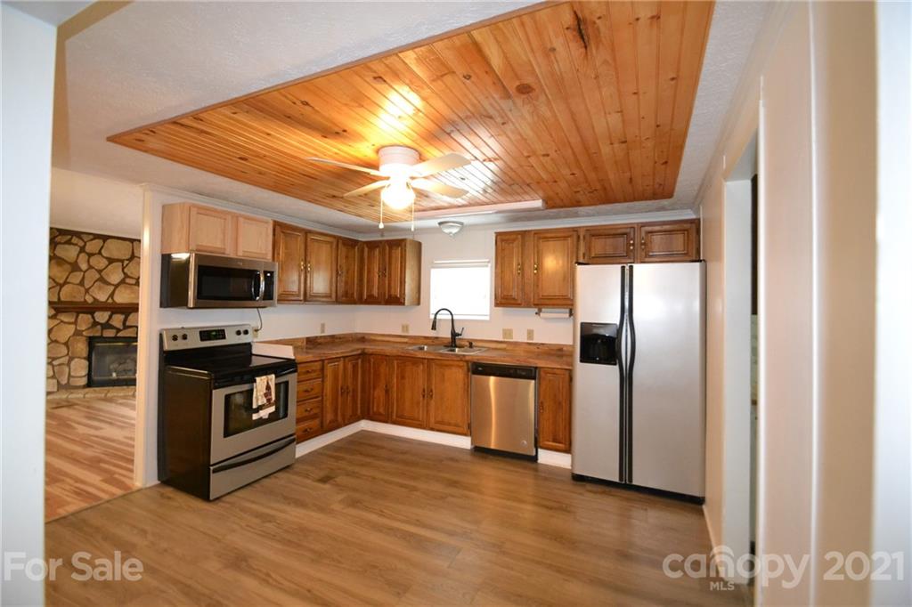 3511 Thunder Road Maiden, NC 28650 - Photo 19 of 44 a kitchen with stainless steel appliances granite countertop a refrigerator a stove top oven a sink and dishwasher