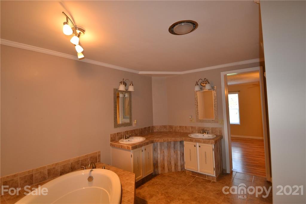 3511 Thunder Road Maiden, NC 28650 - Photo 23 of 44 a bathroom with a granite countertop sink and a mirror