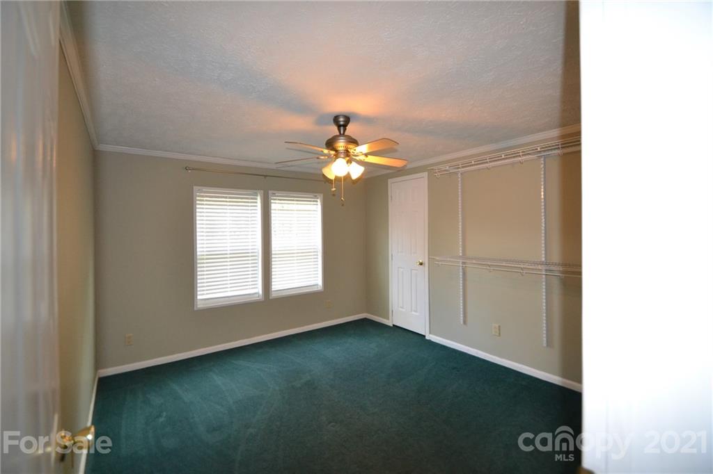 3511 Thunder Road Maiden, NC 28650 - Photo 25 of 44 an empty room with chandelier fan and windows