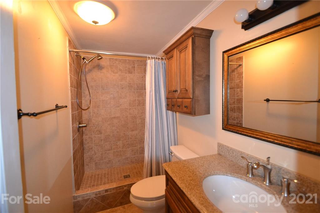 3511 Thunder Road Maiden, NC 28650 - Photo 26 of 44 a bathroom with a granite countertop sink toilet and shower