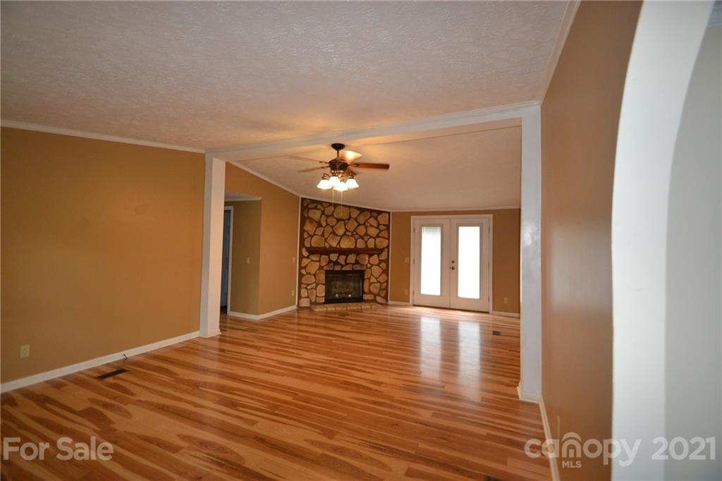 3511 Thunder Road Maiden, NC 28650 - Photo 10 of 44 a view of an empty room with wooden floor fireplace and a window