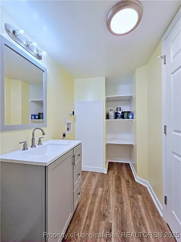 a hallway with a sink and a mirror