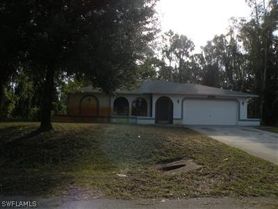 18213 Maple Road Fort Myers, FL 33967 - Photo 1 of 9 a front view of a house with garden