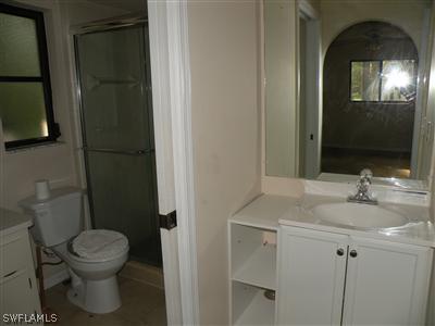 18213 Maple Road Fort Myers, FL 33967 - Photo 4 of 9 a bathroom with a sink a toilet and shower
