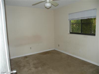 18213 Maple Road Fort Myers, FL 33967 - Photo 8 of 9 an empty room with windows