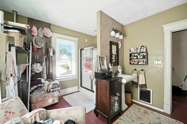 a living room with furniture mirror and a table