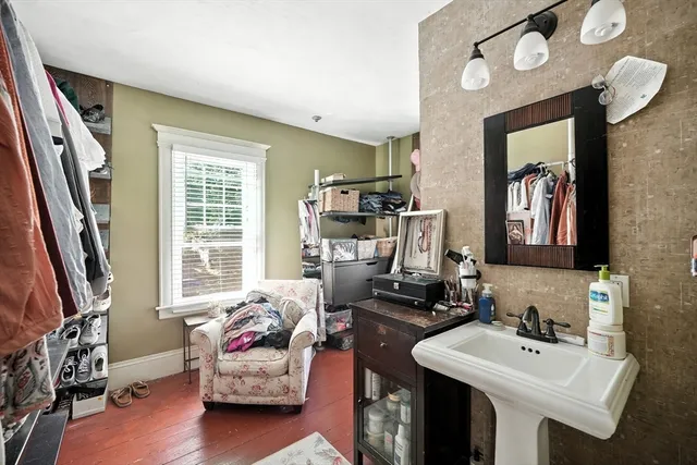 a bedroom with furniture and a window