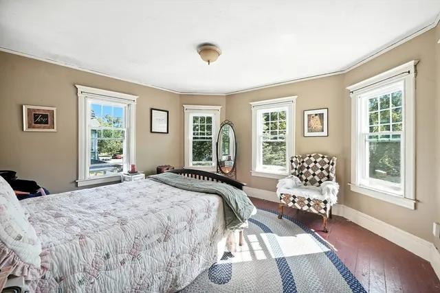 a bedroom with a bed and glass window