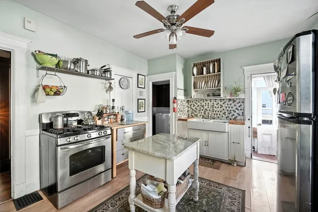 a kitchen with a stove a sink and a refrigerator
