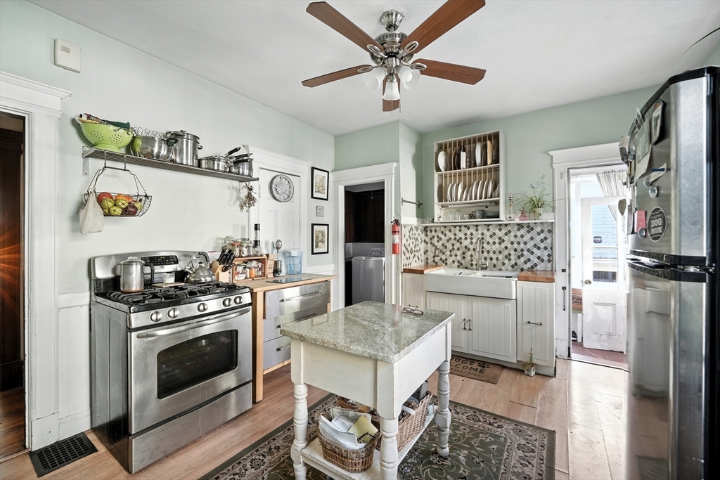 96 Firglade Avenue Springfield, MA 01108 - Photo 8 of 31 a kitchen with a stove a sink and a refrigerator