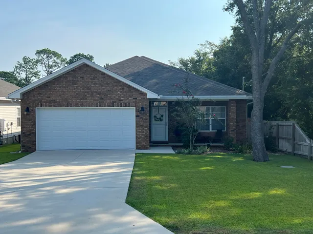 a front view of a house with a garden and porch